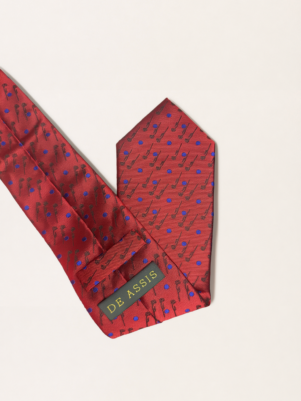 A red silk necktie with a repeating rose pattern