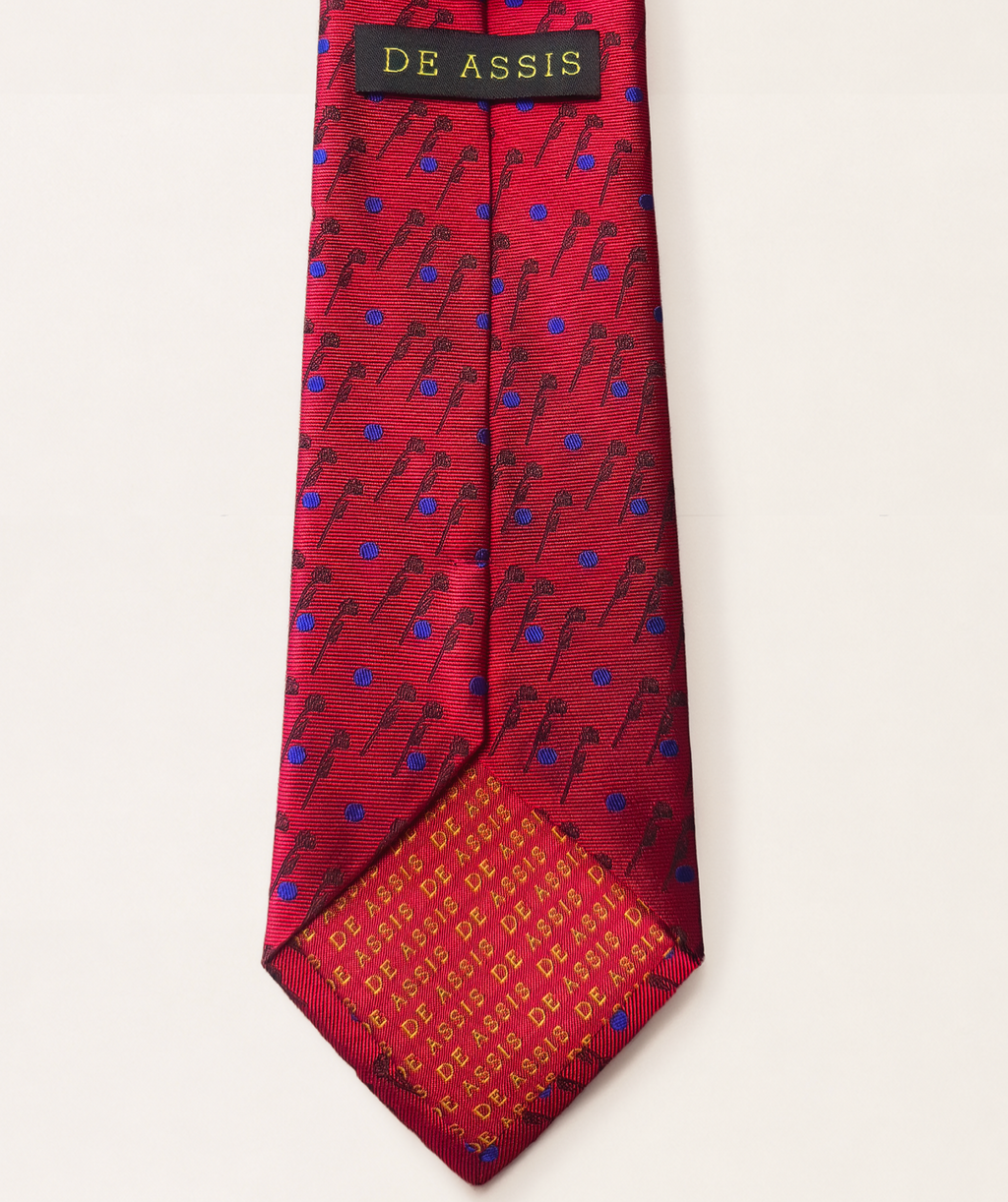 A red silk necktie with a repeating rose pattern